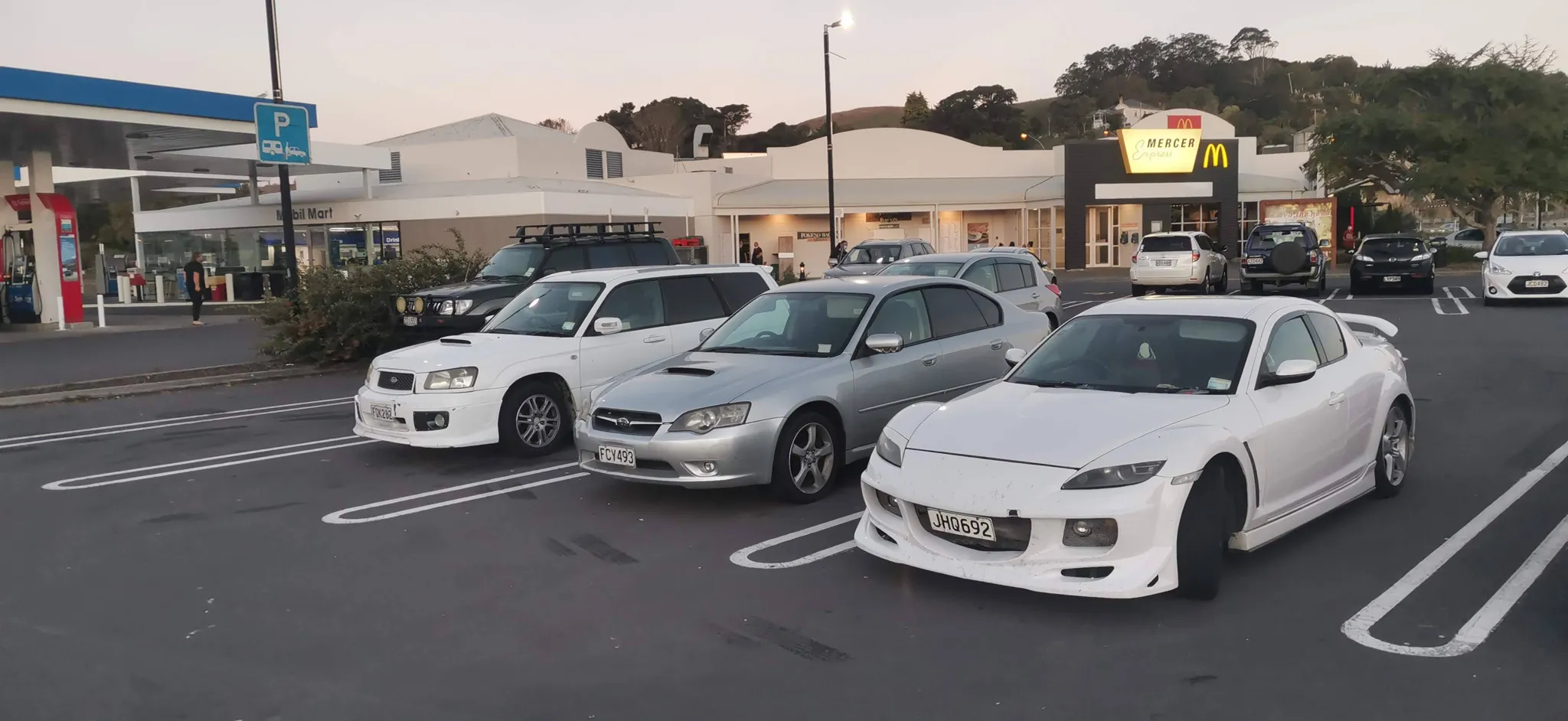 A travel stop with cars parked together during a trip